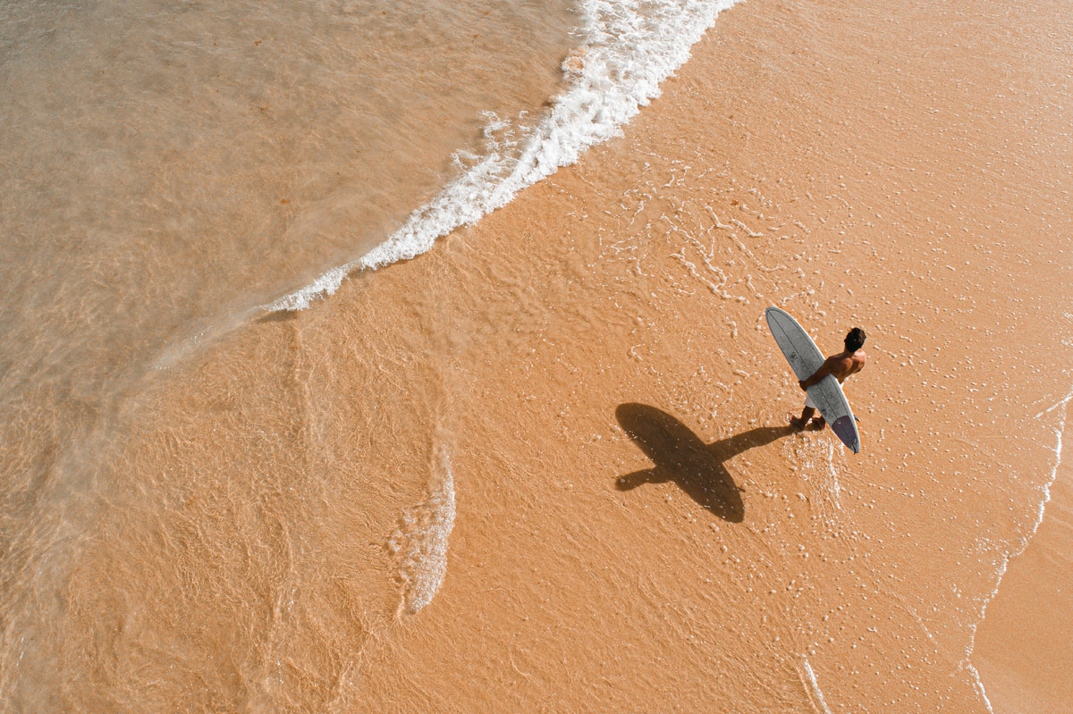 Male surfer near the sea in Vilamoura's beautiful beaches