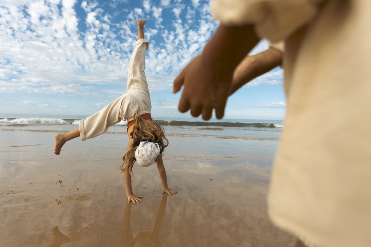 Girl doing a cartwheel on the Vilamoura's beautiful beaches