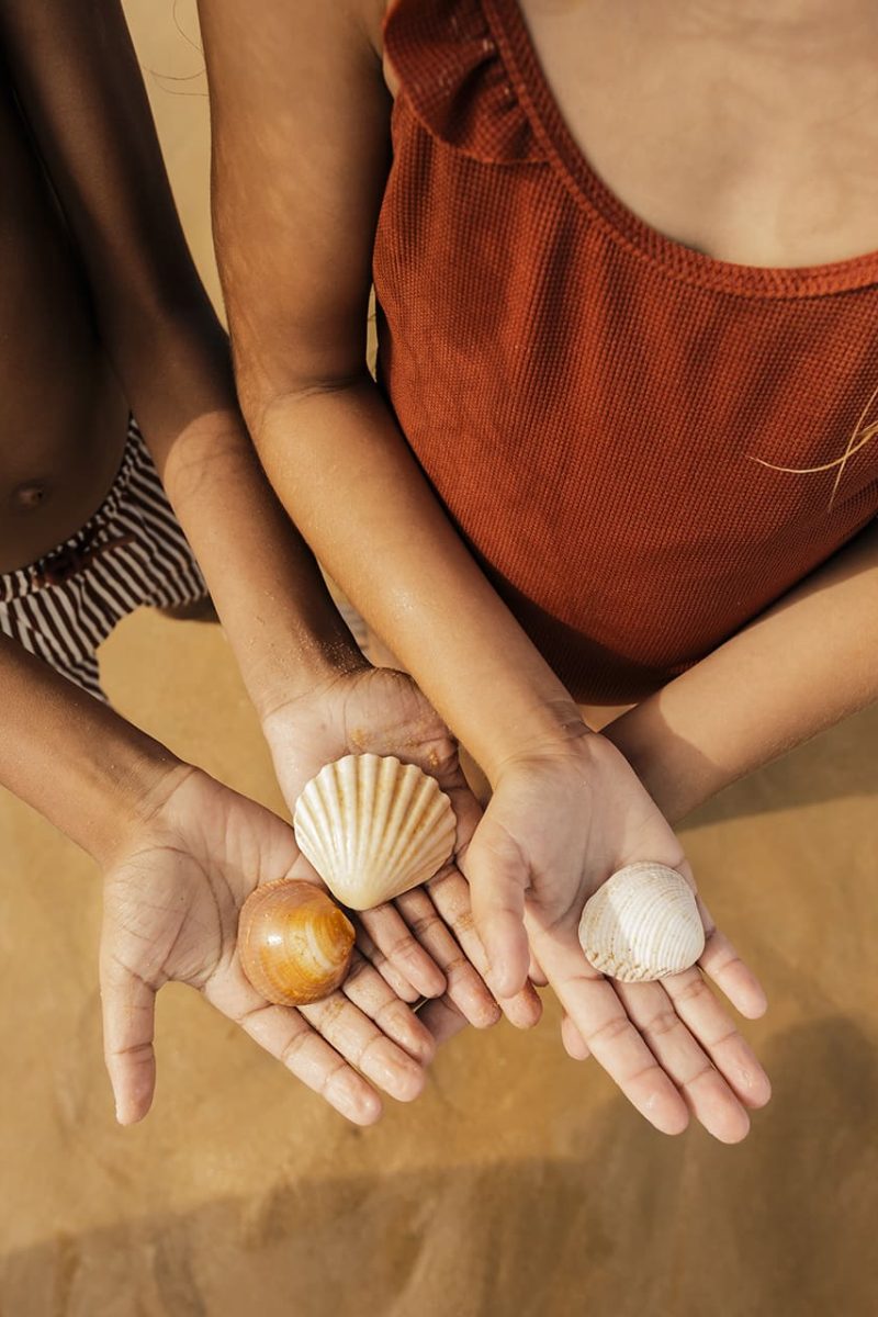 Kids playing with seashells Vilamoura's beautiful beaches